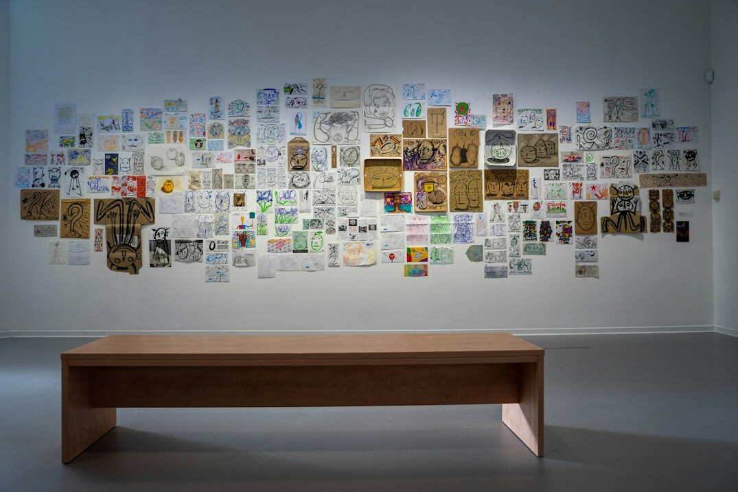 Desk covered with printed photographs and film negatives