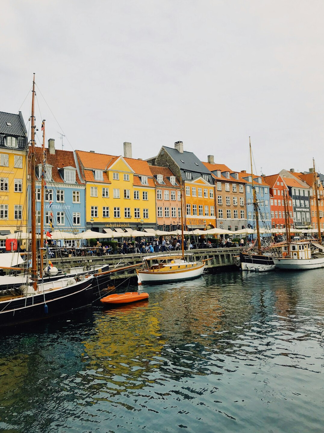 Colorful harbor houses and boats in Copenhagen at dusk