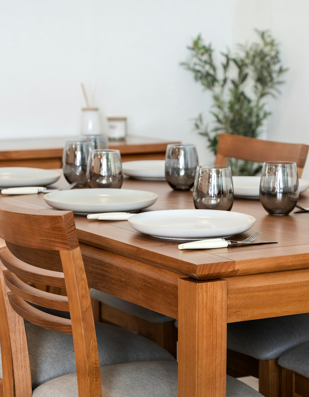Danish family sharing dinner at a wooden table in the evening