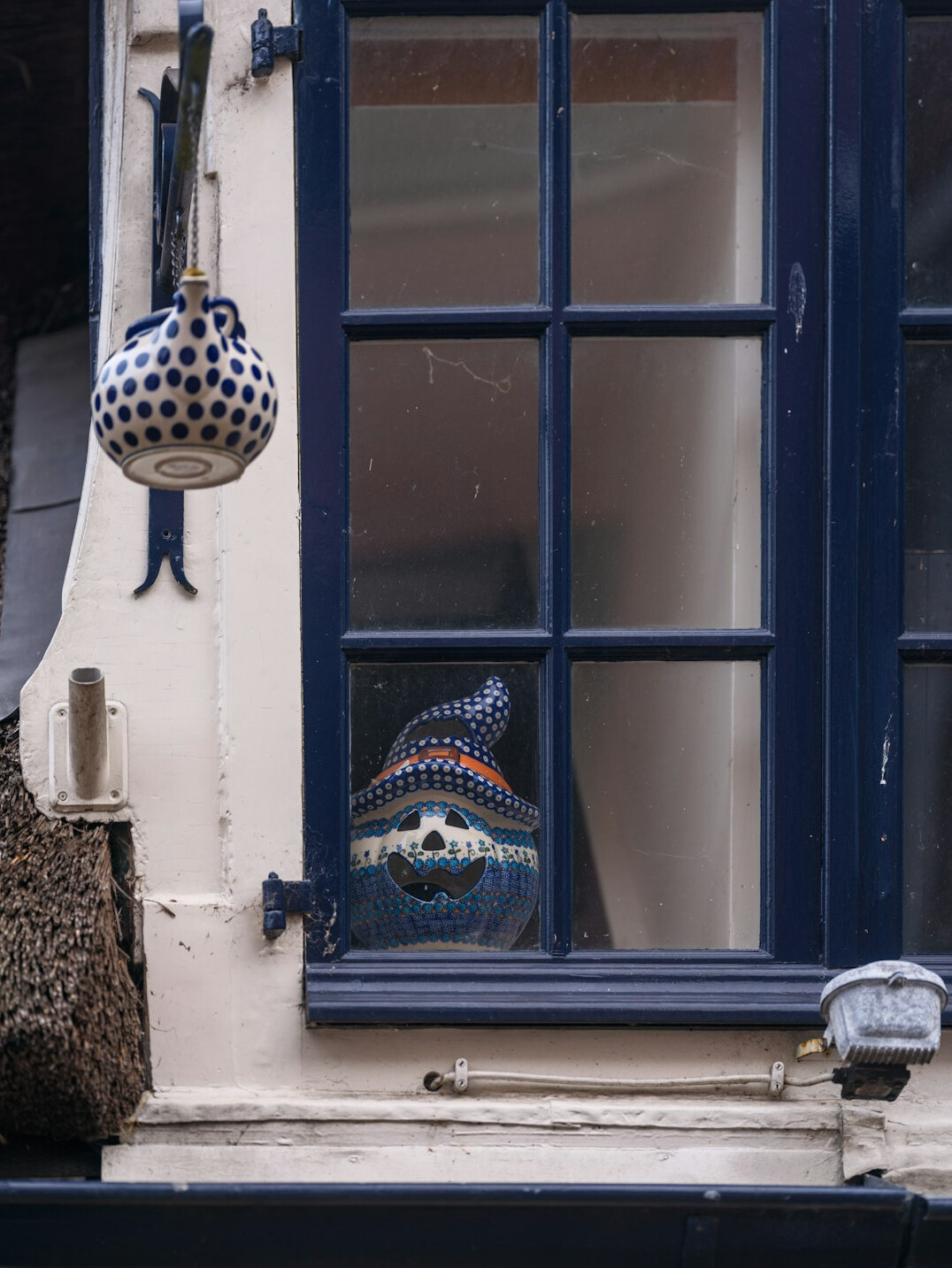 Elderly Danish woman knitting wool by a window