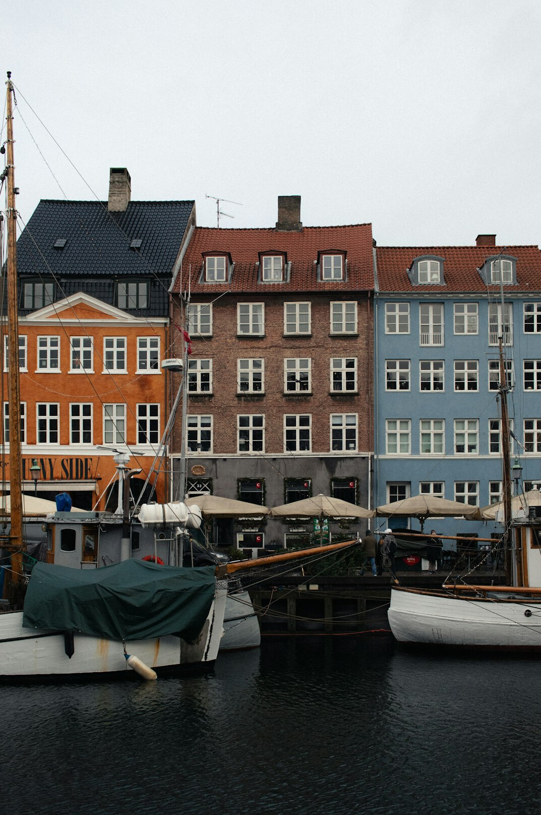 Colorful townhouses and wooden boats along Nyhavn canal