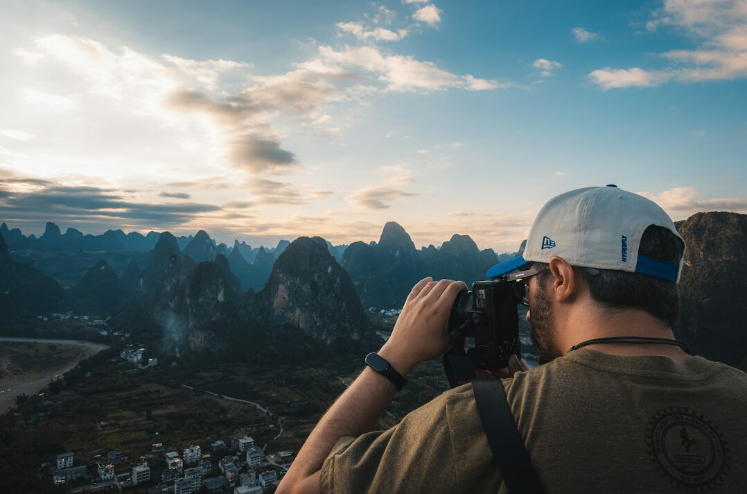 photographer with camera in village